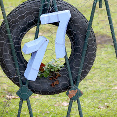 house number 17 in a contruction with a tire and a fence