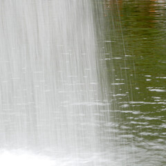 Little waterfall in an artificial lake of a public park 