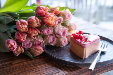 Delicious dessert cake and pink tulips for romantic mothers day morning. Close-up. - 770648407