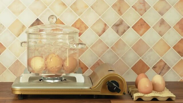 Eggs boiling in a glass pot