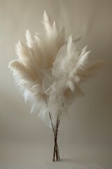 A striking arrangement of white feathers resembling flowers on a neutral backdrop