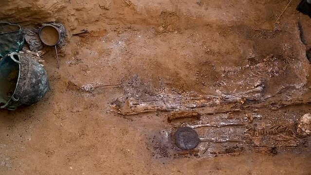 Archaeological excavations of ancient tombs. The remains of a human skeleton, household utensils, jewelry and jewelry found in an ancient tomb. The work of archaeologists