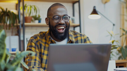 man working on laptop laughing, man working from home, home office, meeting