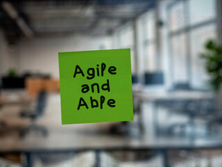 Post note on glass with 'Agile and Able'.