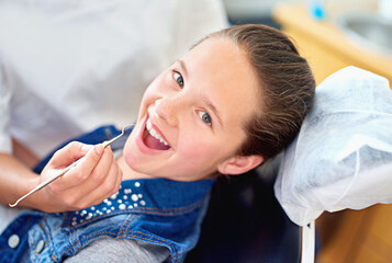 Girl, child and portrait at dentist for dental with healthcare tool, consultation or mouth inspection for oral health. Professional, kid patient or hand for teeth cleaning, gingivitis or medical care