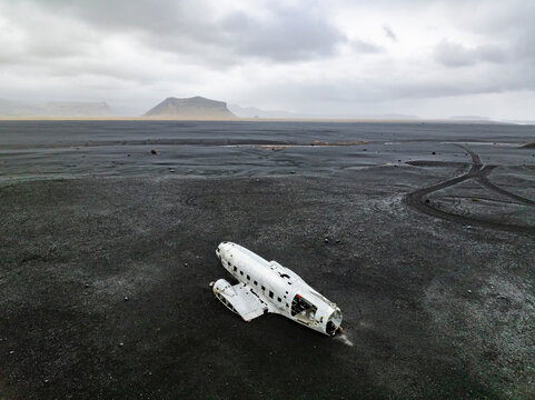 Aerial view of abandoned plane wreck on black sand beach, Solheimasandur, Southern Region, Iceland. - Powered by Adobe