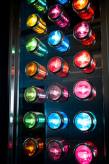 A close-up of a colorful, modern control panel featuring many colorful buttons. Rows of electronic, luminous round buttons, operating machinery and appliances in an industrial setting. AI-generated
