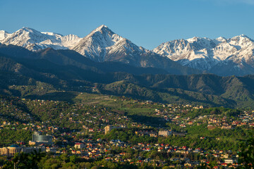 The foothills of the Kazakh city of Almaty lined with houses on a spring morning