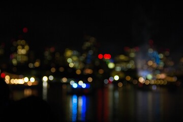 Blurred shot of a vibrant metropolitan cityscape at night, with the twinkling lights of buildings