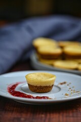 Homemade mini cheesecake muffins with raspberry sauce