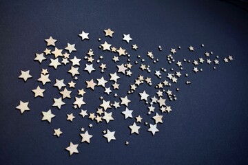 Close-up shot of Wooden stars isolated on a graphite background.