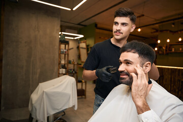 Master barber doing care and new look of hairstyle for male client