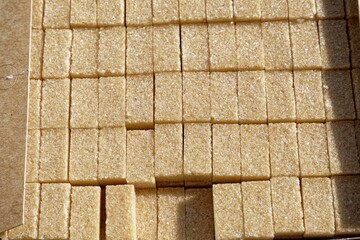 Close-up of a cardboard box filled to the brim with sugar cubes