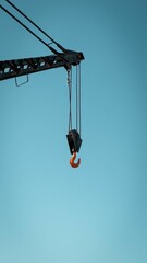 Industrial orange hook attached to a crane lifting equipment