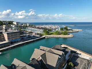 Aerial view of a busy marina situated in a bustling city, featuring bright blue waters