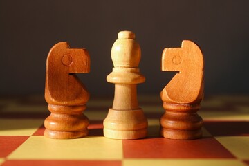 Chessboard with its pieces arranged and ready for a game, illuminated by soft lighting