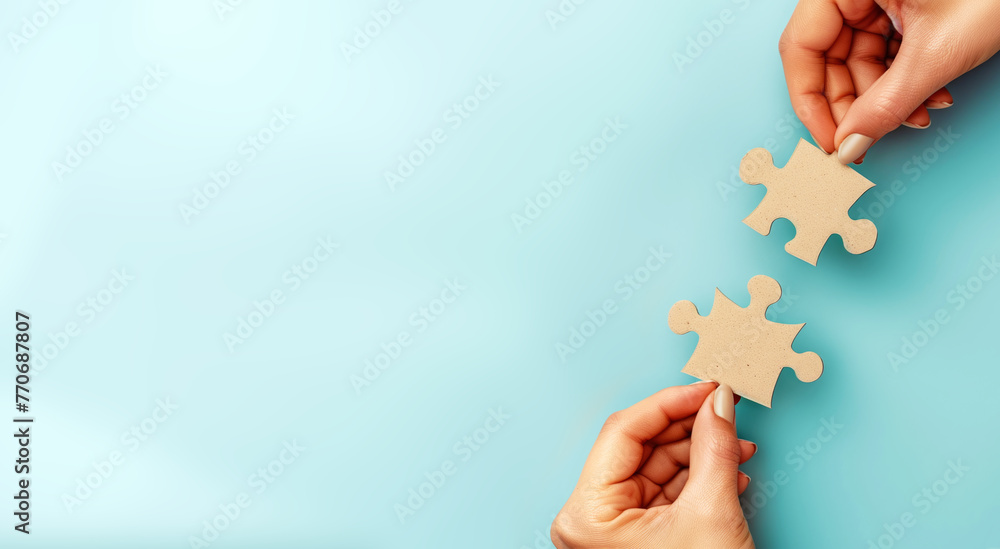 Poster two hands holding jigsaw puzzle pieces on a light blue background, symbolizing connection and soluti