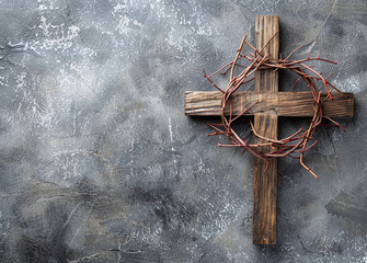 Easter wooden cross and crown of thorns on gray background with copyspace