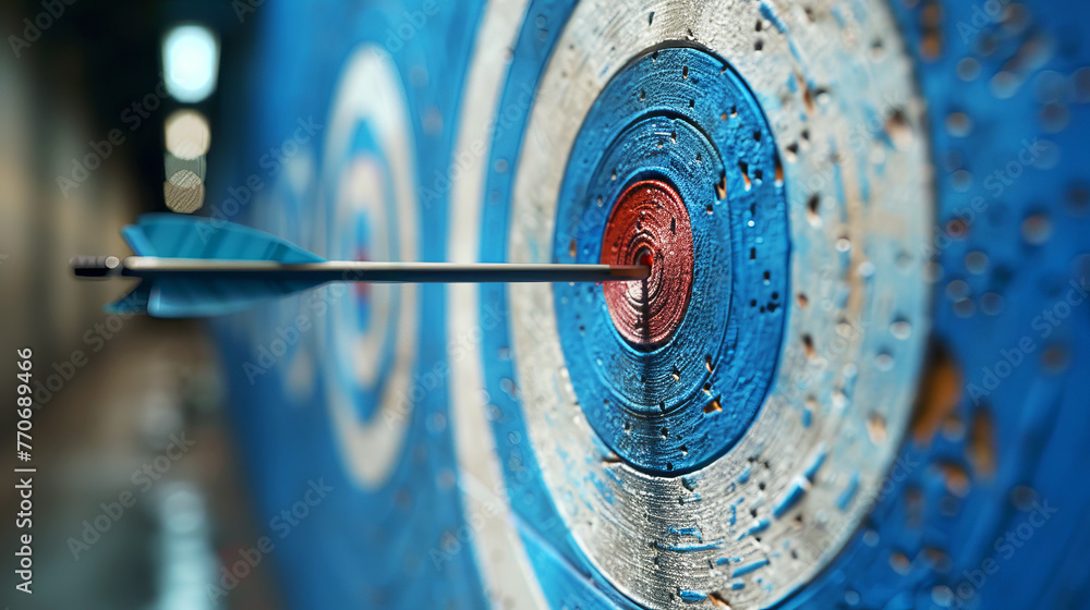 Poster close-up of a blue dart hitting the bullseye on a target, symbolizing goal achievement and precision