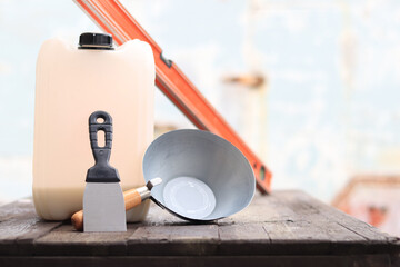 Construction or plastering ladle, a spatula, a construction level and a container for primer....