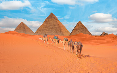 Camel caravan in front of the Great pyramid of Giza complex - Cairo, Egypt