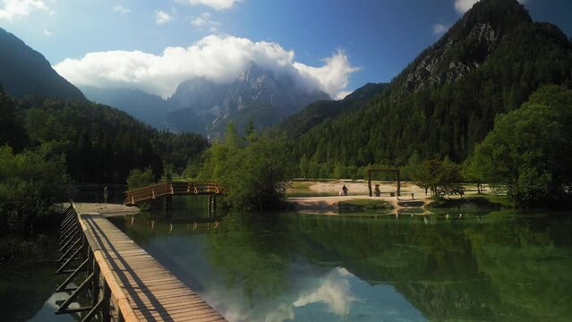 Lake Jasna on a sunny day with Julian Alps in the background near Kranjska Gora, Slovenia