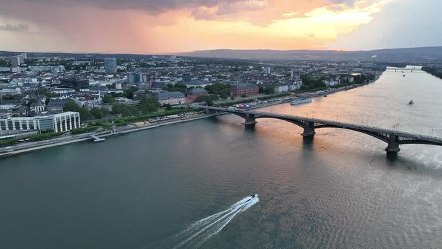 Aerial footage of speed boat sailing on Rhine River going under Theodor Heuss Bridge, Germany