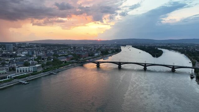 Ascending drone footage of Theodor Heuss Bridge and Mainz city on Rhine River in Germany at sunset