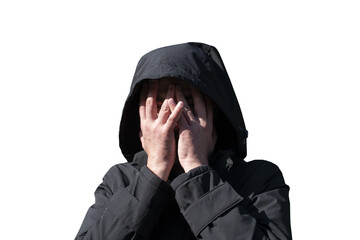 A man in a hood covering his face with his hands