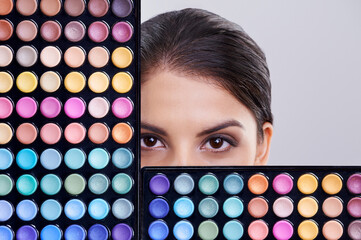 Beauty, makeup palette and portrait of woman in studio for cosmetics, powder and foundation on gray...