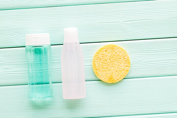 Organic cosmetics for face clearing with sponge, facial tonic, mycelial water on mint green background top view mockup