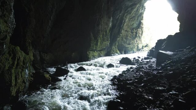 Drone footage of water flowing in Weaver Cave during daytime in Rakov Skocjan Valley, Slovenia