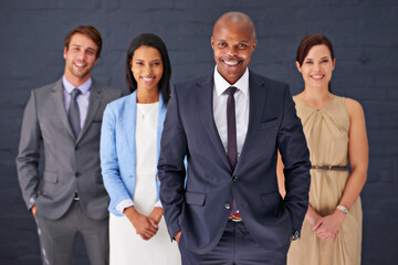 Business people, portrait and confidence with team standing ready in corporate fashion on a gray studio background. Group of employees with smile in stylish or formal clothing for career ambition