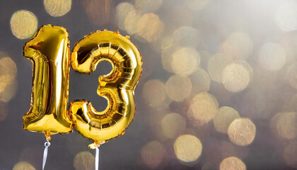Banner with number 13 golden foil balloon with copy space. 13 years anniversary celebration.