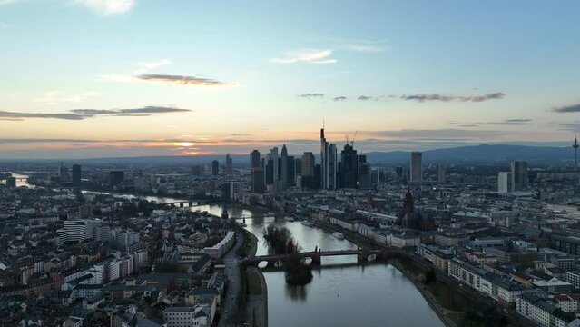 High drone footage of the Frankfurt skyline and the Main tributary of the Rhine at sunset, Germany