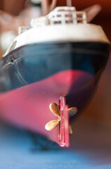 Close-up on a toy boat made of wood. Shallow depth of field