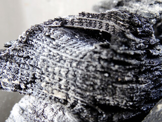 Textured partial burned or used charcoal close-up