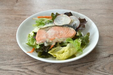 Fototapeta na wymiar gelled salmon with mixed vegetable salad dressing spicy and sour seafood cream sauce on plate