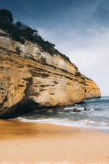 Loch Ard Gorge surrounded by the sea under a cloudy sky in Australia