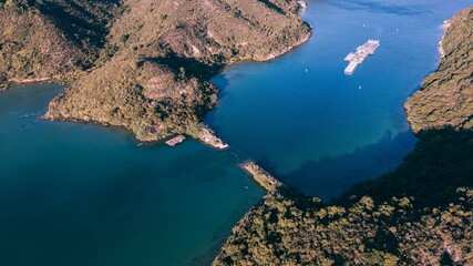 Aerial view of sea surrounded by mountains - obrazy, fototapety, plakaty