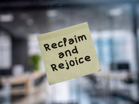 Post note on glass with 'Reclaim and Rejoice'.