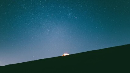 Beautiful view of an illuminated tent under a starry sky