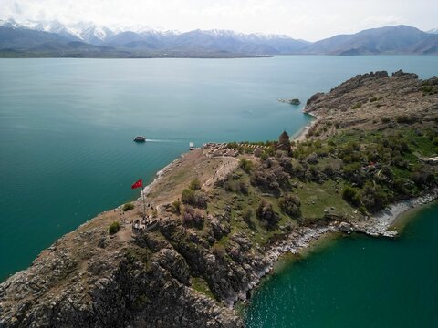 Aerial view of Akdamar Island in Turkey with a historic Armenian church and boats near the shore