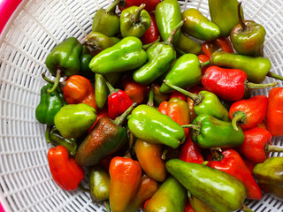 The large red and green chilies look fresh in the basket