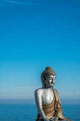 Statue of a Thai Buddha on the shores of the Mediterranean Sea