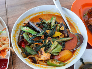 background of smoked fish coconut milk curry with vegetable and tomato toppings