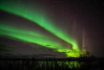 Stunning aurora borealis illuminating the night sky above the rural landscape.