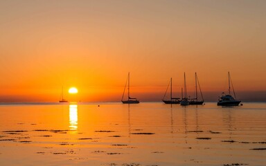 Mesmerizing view of the boats sailing on Isle of Arran at sunrise