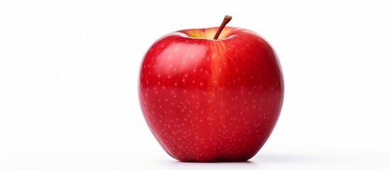 A single red apple with a yellow stem, known as a seedless fruit, stands out against a white background. This superfood is a staple for natural foods lovers