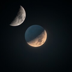 Lunar phases rising over the city in night sky